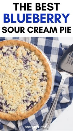 the best blueberry sour cream pie on a checkered table cloth with silverware