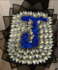 a blue and white flower arrangement on top of a black table