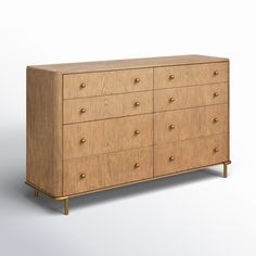 a wooden dresser with brass handles and knobs on the bottom drawer, against a white background