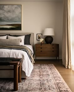 a bed sitting next to a window in a bedroom