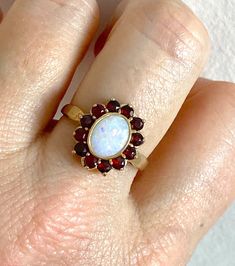 Absolutely stunning Opal and Garnet statement ring. This beautiful cluster ring is a real eye catcher and would make a great gift. All the stones are in excellent condition, no wear at all. CONDITION: Excellent, like new CURRENT FINGER SIZE : UK size Q, but can be altered to sizes on drop down menu. This ring has been professionally checked, cleaned and polished. Comes in a new box. Monogram Ring Gold, Opal Statement Ring, Opal Ring Vintage, Witch Rings, Edwardian Jewelry, Mens Gold Jewelry, Monogram Ring, Garnet Ring, Funky Jewelry