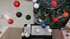 an arrangement of balls and pins are on display at a science fair or graduation party