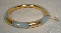 A 14k and jadeite bangle bracelet from the 1930s. This exceptional vintage round yellow gold and genuine natural jadeite bracelet has hand engraved gold encasing or wrapping around the light green mottled jade.  Unlike many examples this one has continuous gold around the interior and six wraps around the jade hoop.  It measures 2-3/8" across the interior wall (inside of bangle measurement) and is 5/16" wide or thick. It has a typical clasp with a heart shaped button.  It is stamped 585 and 14K Antique Round Jade Jewelry, Vintage Jade Round Bracelets, Vintage Round Jade Bracelets, Round Jade Collectible Jewelry, Vintage Jade Bracelets, Collectible Round Jade Jewelry, Vintage Jade Bangle, Antique Accessories, Art Deco Jewelry Vintage