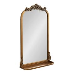 a large mirror sitting on top of a wooden shelf