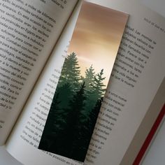 an open book with trees on it