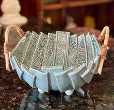 a ceramic bowl with handles on a table