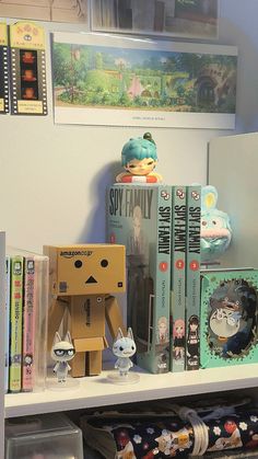 some books and toys on a shelf in a room