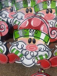 a group of santa claus ornaments sitting on top of a sidewalk