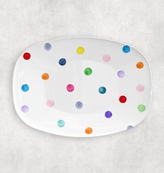 a white plate with multicolored polka dots on it