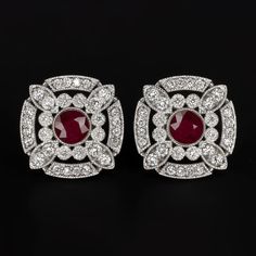 Why we love it:These elegant and brilliantly sparkling stud earrings bring the glamour with a chic and sophisticated Art Deco style design! Featuring a gorgeous 0.62ct pair of rich red rubies, the geometric double halo design glitters with an additional 0.40ct of vibrant pave set natural diamonds.Highlights:- 0.62ct pair of natural rubies with a rich red hue- 0.40ct of bright white and eye clean natural diamonds- Elegant geometric design- Classic 14k white gold settingsDimensions:The earrings me Luxury Ruby Earrings With Halo Design, Luxury Ruby Jewelry In Art Deco Style, Art Deco Ruby Earrings, Luxury Classic Ruby Earrings, Classic Ruby Diamond Earrings With Accents, Sophisticated Art, Pakistani Jewelry, Ruby Earrings, Ruby Diamond