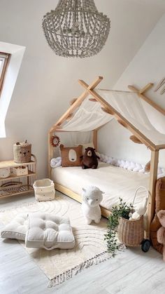 a child's room with a bed, teddy bears and a chandelier