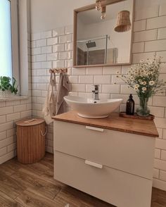 a bathroom with white tiles and wooden counter tops