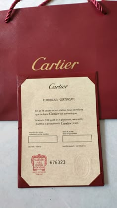 a red bag with a certificate attached to it