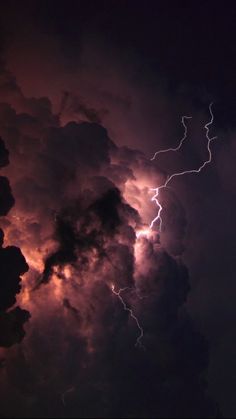 lightning striking through the clouds at night