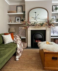 a living room filled with furniture and a fire place next to a couch in front of a fireplace