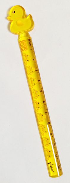 a ruler with a rubber ducky on the side and measuring tape attached to it