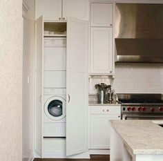 a kitchen with an oven, stove and washer inside of it's door