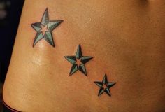 three stars on the side of a woman's stomach