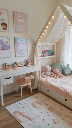 a child's bedroom decorated in pink and white