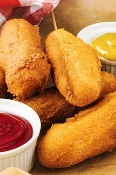 fried food items displayed on wooden table with dipping sauces