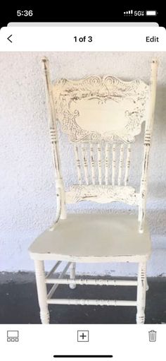 a white chair sitting next to a wall