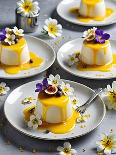 four small desserts on plates with flowers and saucer in the middle one is yellow