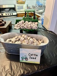 a table topped with lots of food next to a green carton filled with rocks