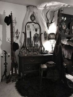 a bedroom with an old fashioned dresser, mirror and other items on the wall in black and white