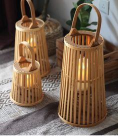 three bamboo lanterns sitting on top of a table