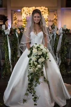 a woman in a wedding dress holding a bouquet