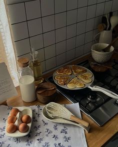 pancakes and eggs are sitting on the kitchen counter