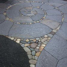 a circular stone path in the middle of a street