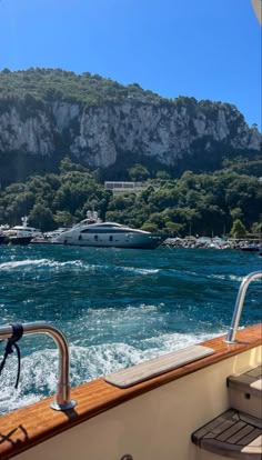 boats are in the water near some mountains