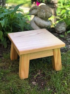 a small wooden stool sitting in the grass