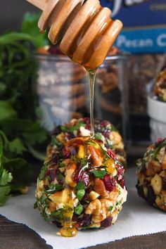 a honey drizzled over some food on top of a napkin