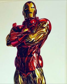 an iron man statue is shown in red and gold foil on a white background,