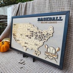 a wooden sign with a baseball map on it next to pumpkins and other items