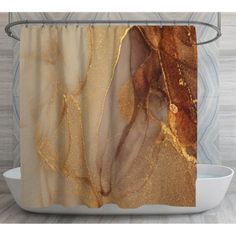 the shower curtain is decorated with gold and brown marbled material, along with a white bowl