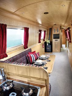 the interior of a motor home with red curtains