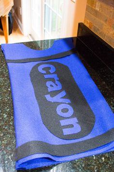 a blue towel sitting on top of a counter next to a stove and oven door