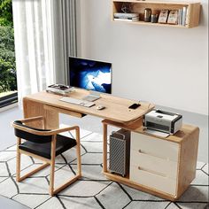 a desk with a computer on it in front of a window and a chair next to it