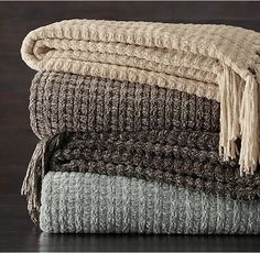 a stack of blankets sitting on top of a wooden table