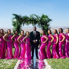 a group of women in pink dresses standing next to each other