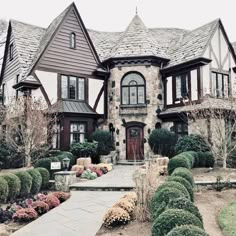 a large house with lots of windows and landscaping