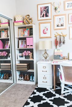 a white desk sitting next to a book shelf filled with lots of books and other items