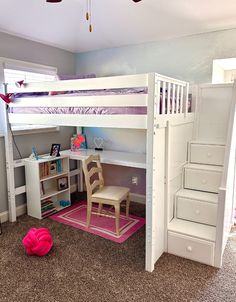 there is a bunk bed with stairs and desk in the room, it has pink rugs on the floor