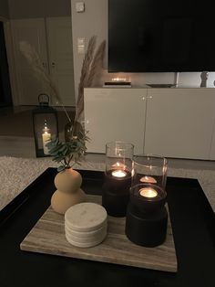 candles are lit on a tray in the living room