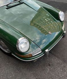 a green sports car is parked on the street