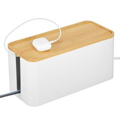 a computer mouse is hooked up to a white box with a wooden lid and handle