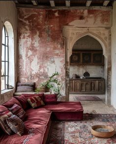 an old living room with red couches and rugs